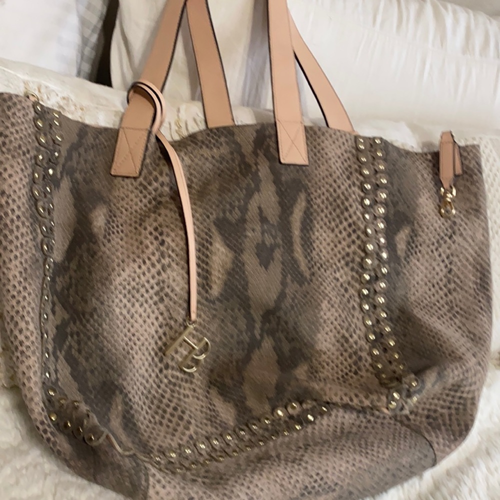 Henri Bendel reversible tote with pouch.